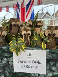 Wooden garden owls with foliage